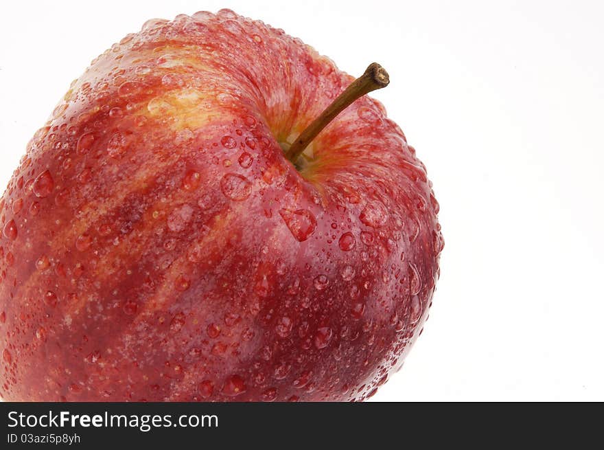 Organic Gala apple covered with drops of water isolated on white background