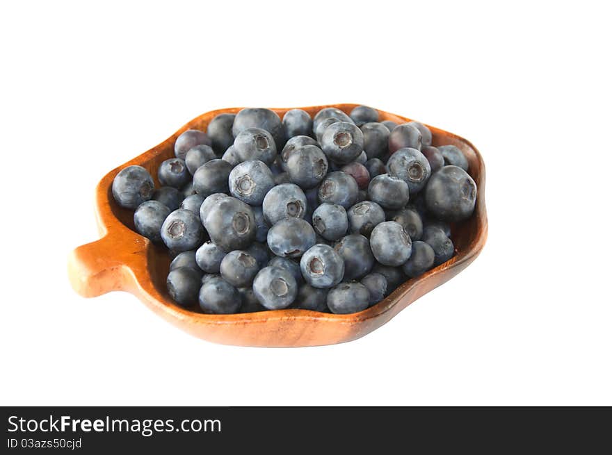 Fresh blueberries in the wooden dish