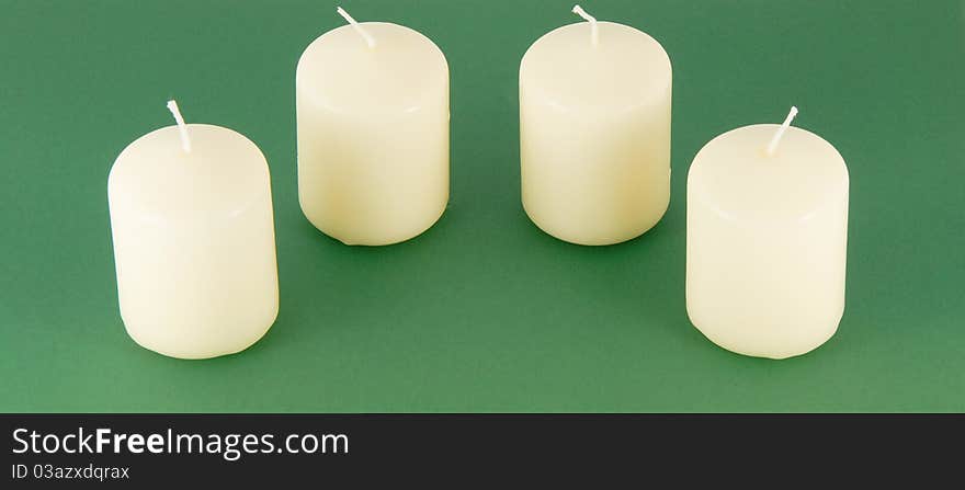 Set of candles on a green background