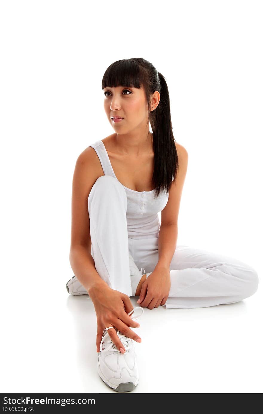 A young beautiful woman wearing fitness clothing and sitting on a white background. She is looking sideways. Pretty mixed race girl asian caucasian. Space for copy. Model Jessica Elms, Makeup Hanae Satomura, Hair by Kayla Cifelli. A young beautiful woman wearing fitness clothing and sitting on a white background. She is looking sideways. Pretty mixed race girl asian caucasian. Space for copy. Model Jessica Elms, Makeup Hanae Satomura, Hair by Kayla Cifelli