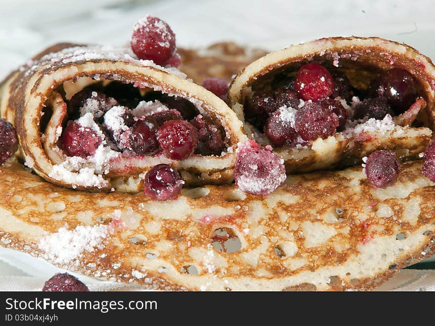 Pancakes with a red berry and sugar close up. Pancakes with a red berry and sugar close up