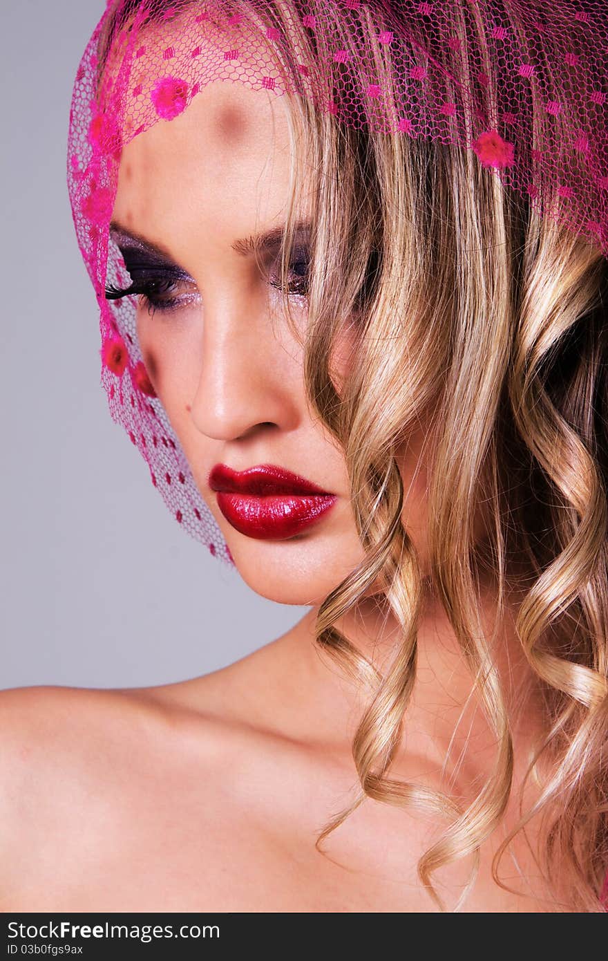 Portrait of a gorgeous woman in a pink veil