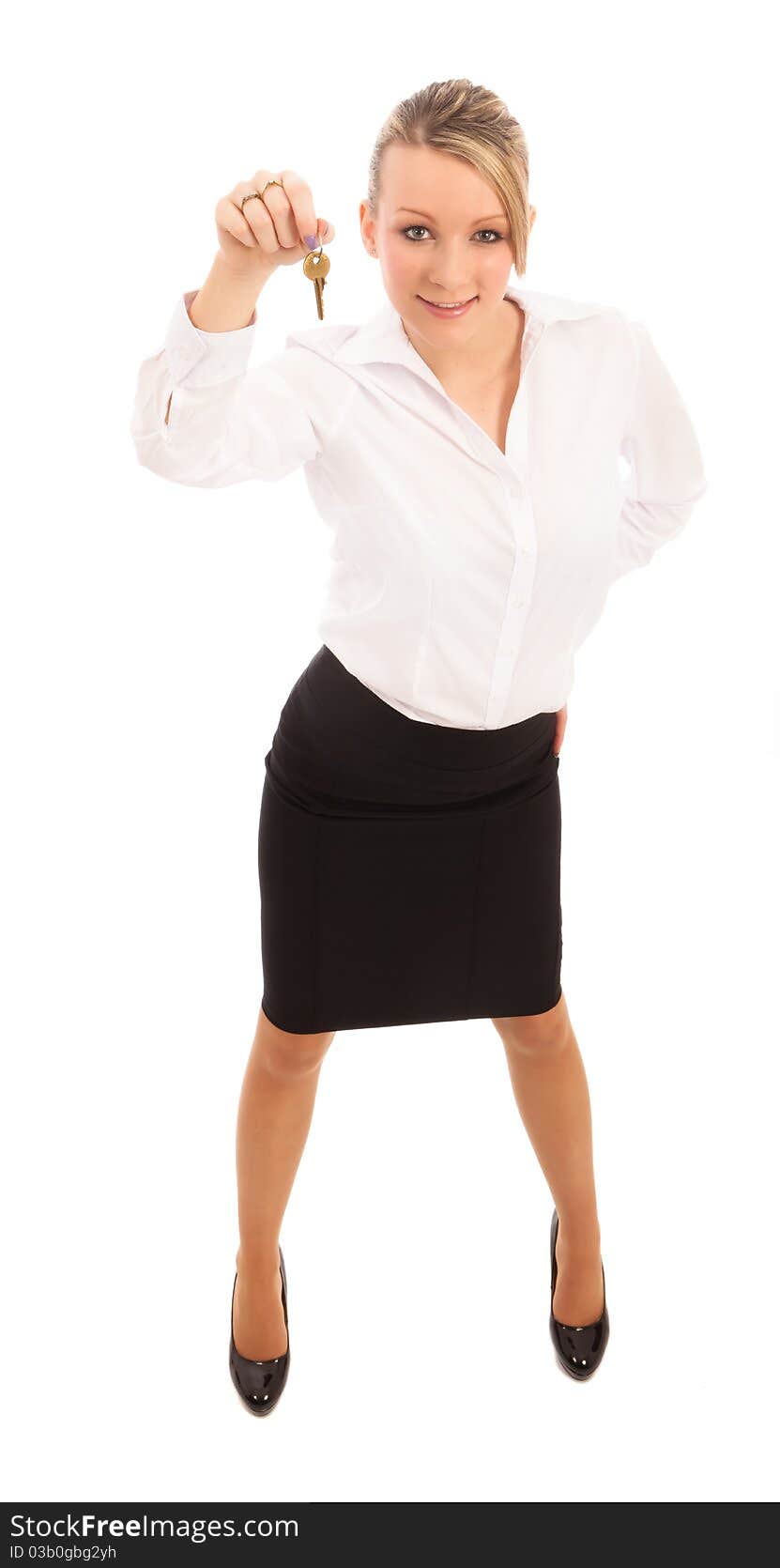 Business Woman in black skirt and white blouse holding a key. Business Woman in black skirt and white blouse holding a key