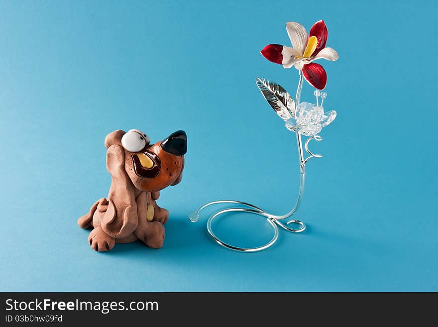 Cute dog ornament that looks at a flower. Cute dog ornament that looks at a flower