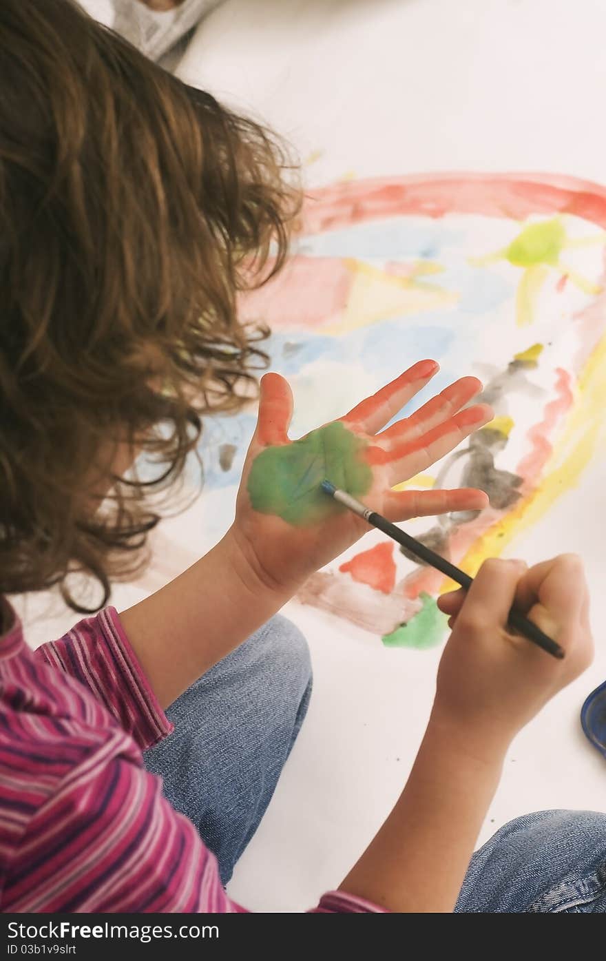 Young girl enjoys painting with watercolors. Young girl enjoys painting with watercolors