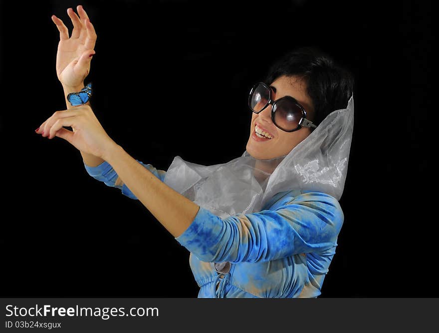 Portrait of young hispanic model wearing sunglasses holding blue butterfly isolated on black. Portrait of young hispanic model wearing sunglasses holding blue butterfly isolated on black