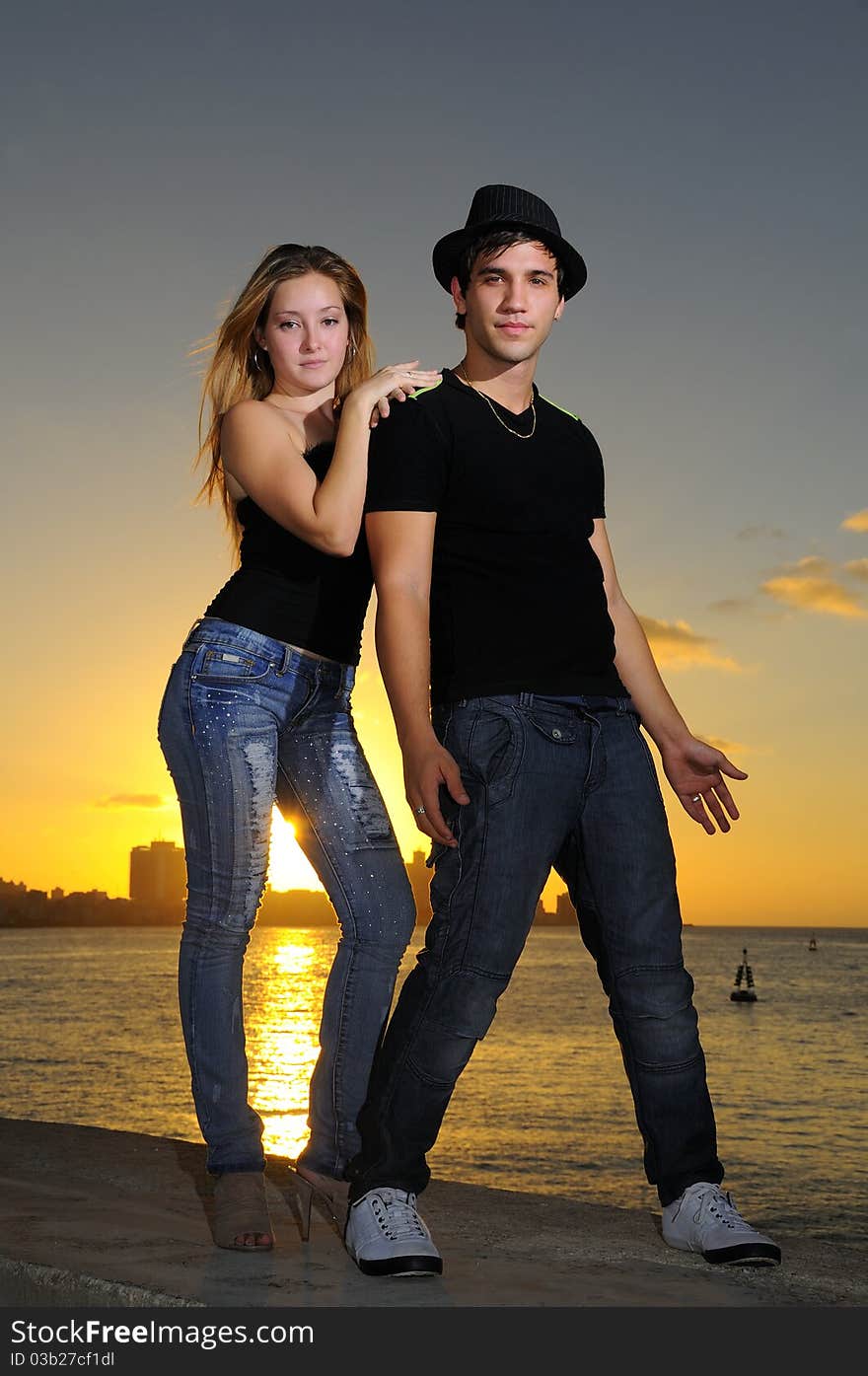 Cool Young Couple Standing At Sunset