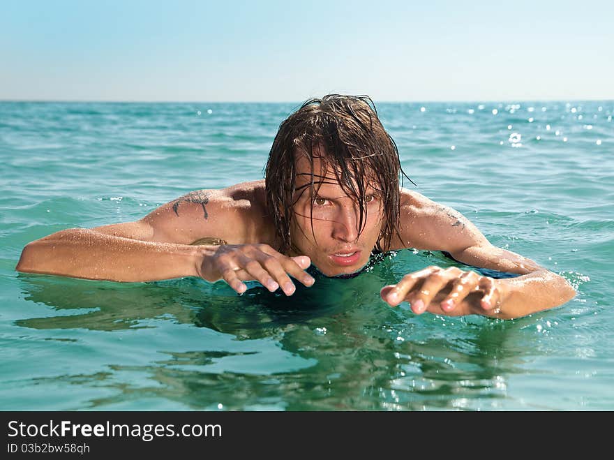 A young boy hiding in the sea and he is preparing to attack. A young boy hiding in the sea and he is preparing to attack