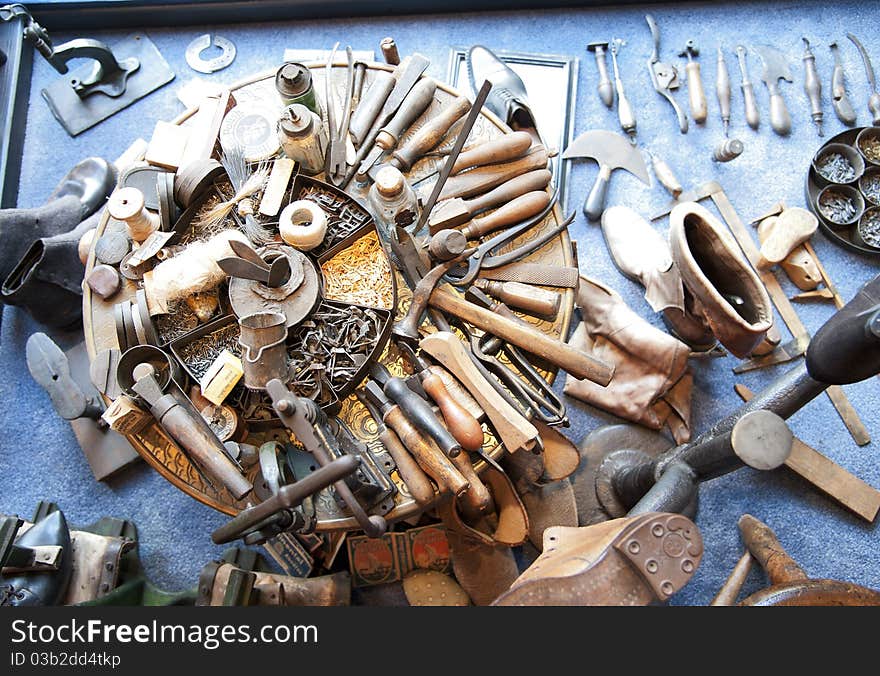 Ancient shoemaker tools decorating a shoemaker shop. Ancient shoemaker tools decorating a shoemaker shop