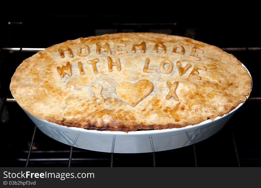 A home made pie with letters on. A home made pie with letters on.