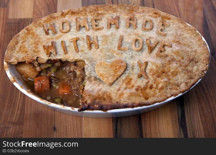 A home made pie with letters on. A home made pie with letters on.