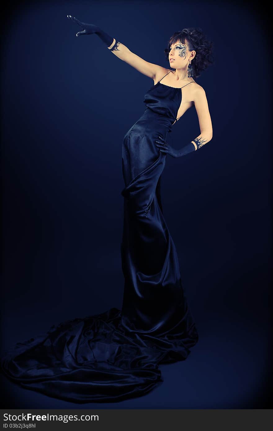 Beautiful fashionable woman in black dress. Studio shot. Beautiful fashionable woman in black dress. Studio shot.