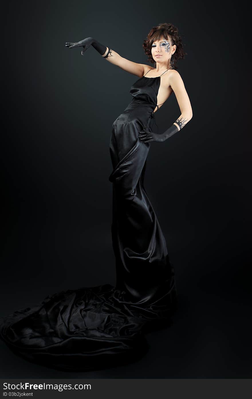 Beautiful fashionable woman in black dress. Studio shot. Beautiful fashionable woman in black dress. Studio shot.