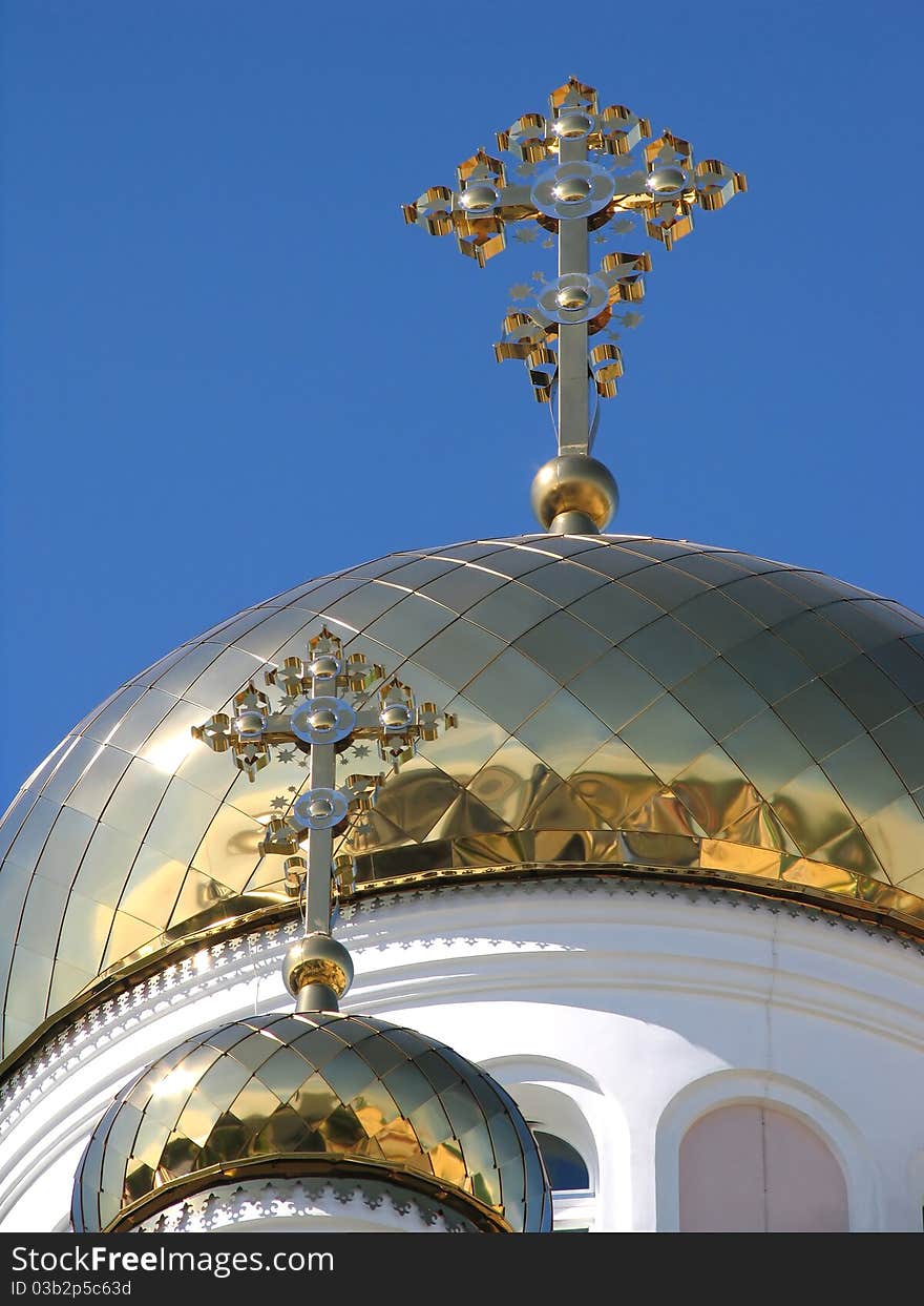 Two gilded dome orthodox church on background blue sky