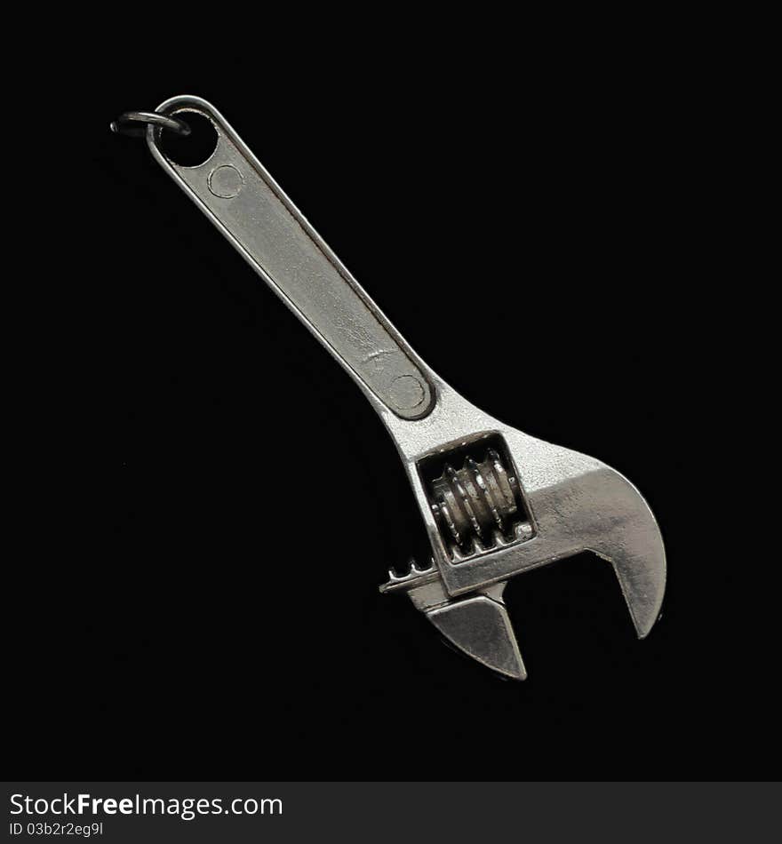 Steel adjustable wrench isolated on black background