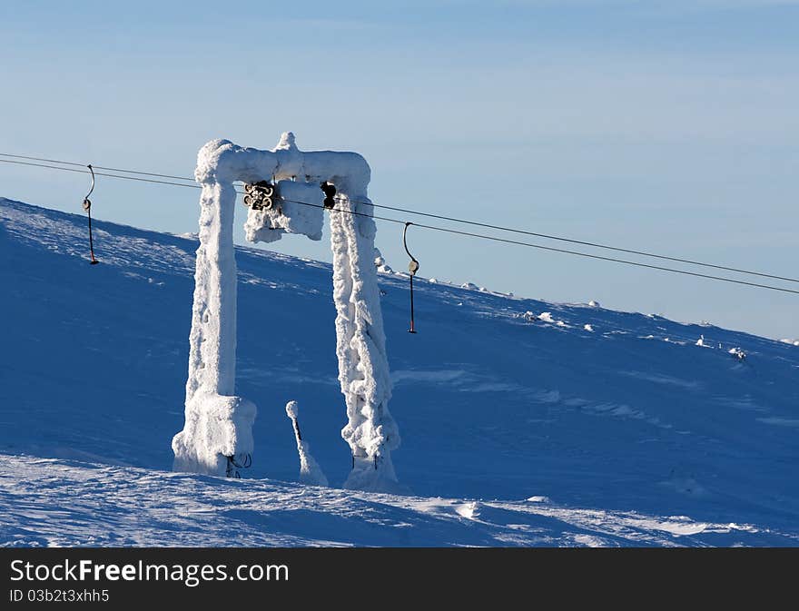 Support the ski lift in the snow against the blue sky