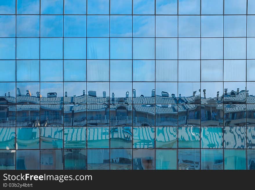 Abstract shapes from a modern building, with reflection of other buildings and sky. Abstract shapes from a modern building, with reflection of other buildings and sky.