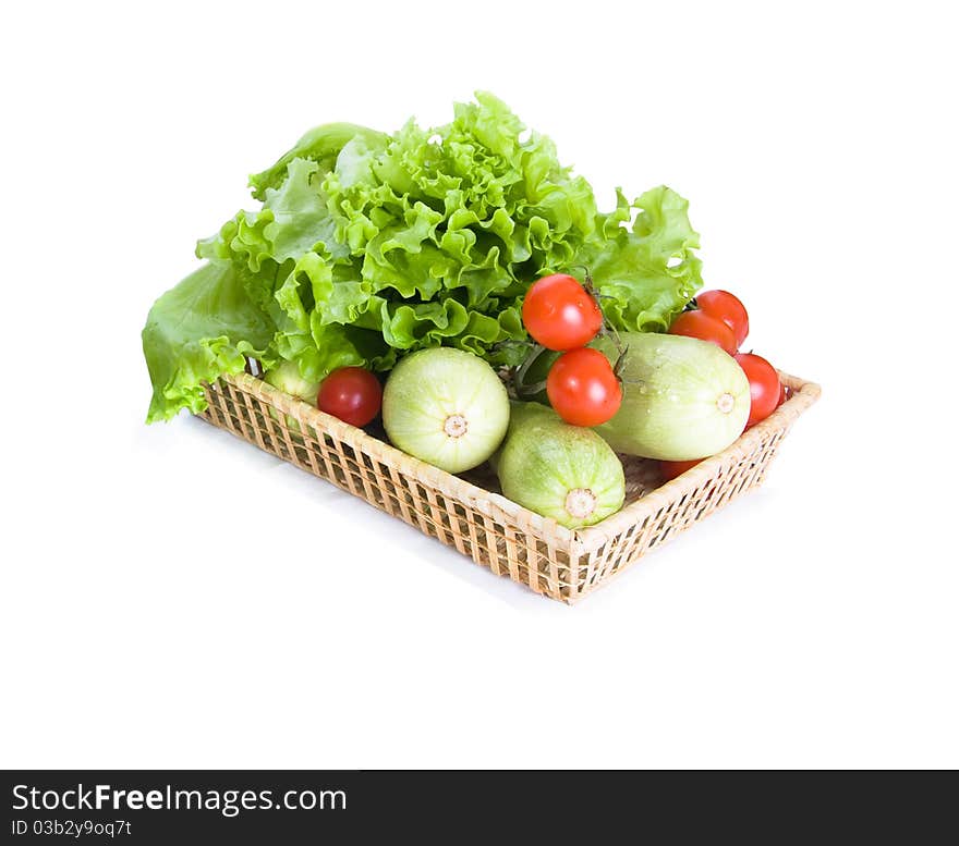 Vegetables are lying on tray from straw on a white background. Vegetables are lying on tray from straw on a white background