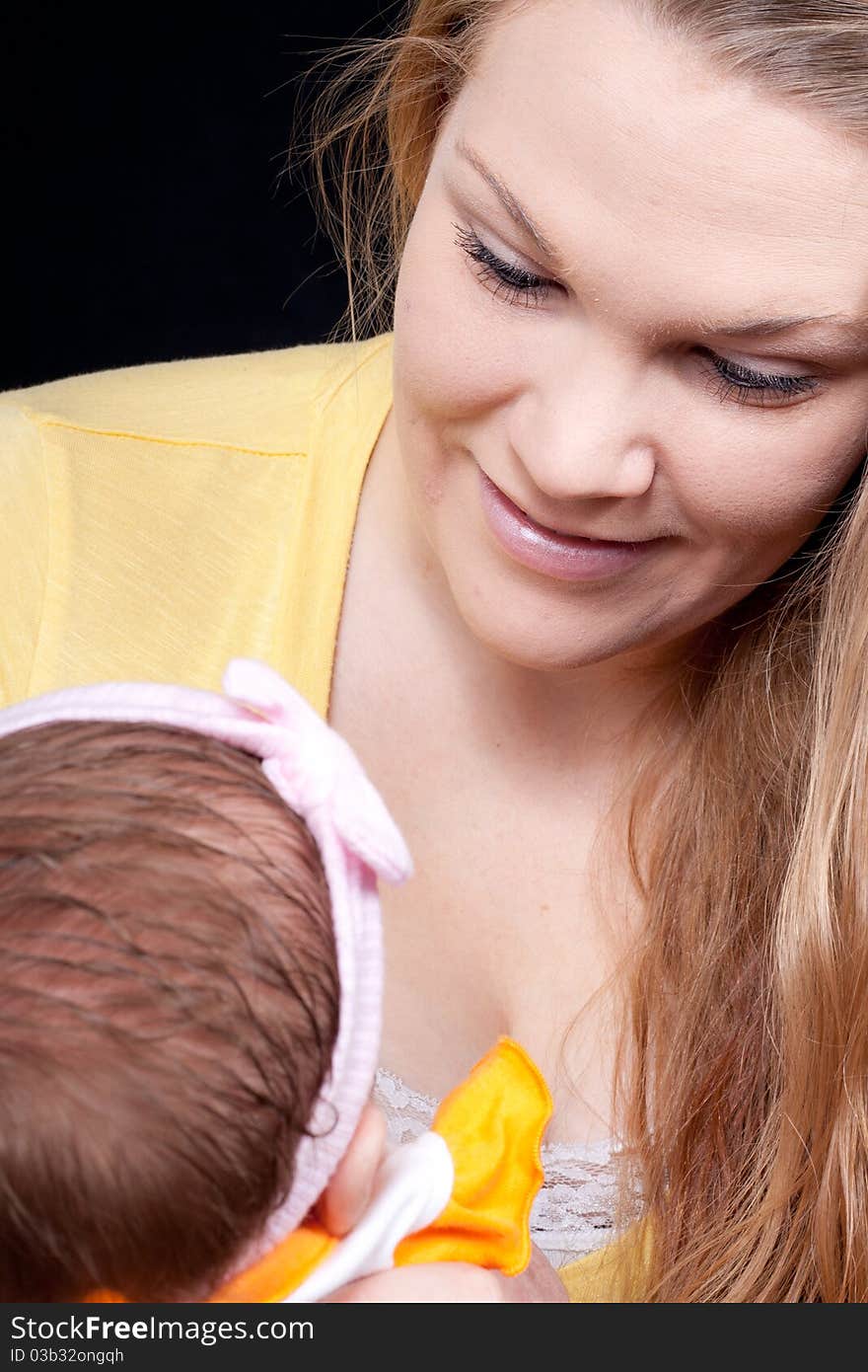 A loving mother holding her precious baby. A loving mother holding her precious baby.