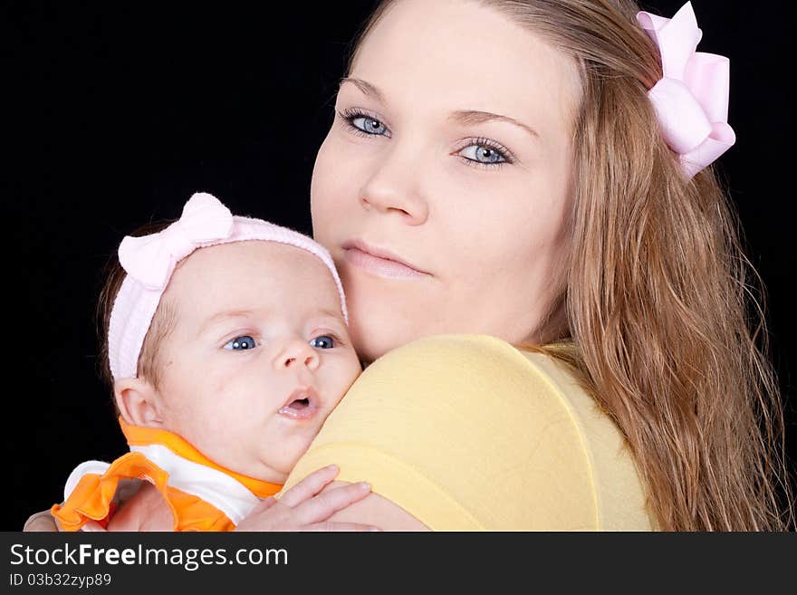 A closeup of a happy mom holding her precious baby.