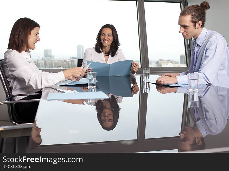 Businesswoman with collegues in front of a panorama window. Businesswoman with collegues in front of a panorama window