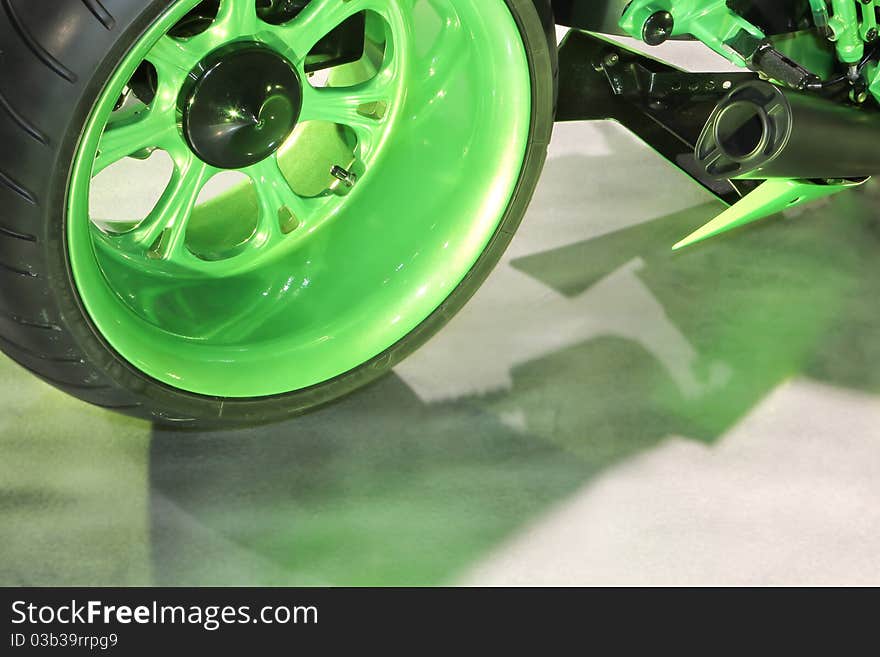 Bright green rear wheel of a custom kawasaki zx-14