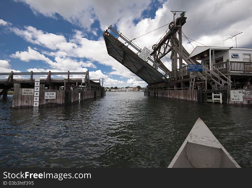 Blue sky with clouds above water and bridge from canoe. Blue sky with clouds above water and bridge from canoe