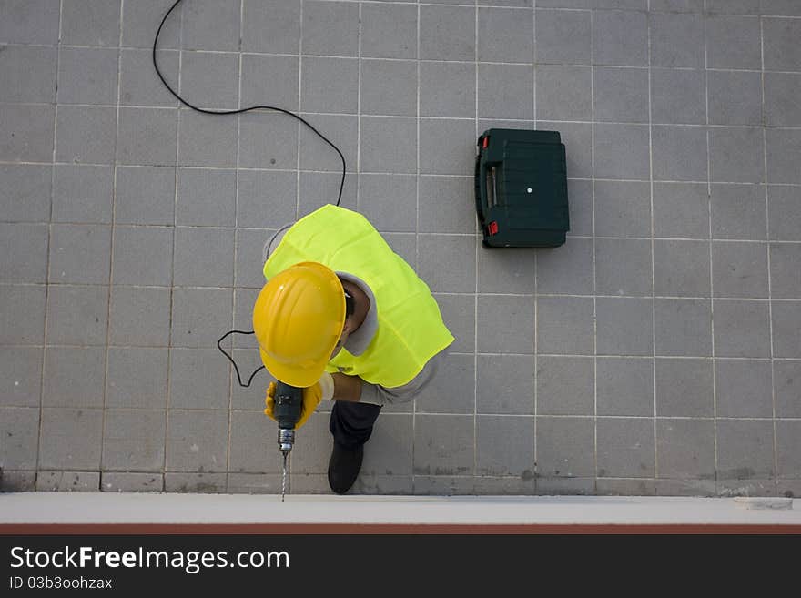 Man drilling a hole on a wall