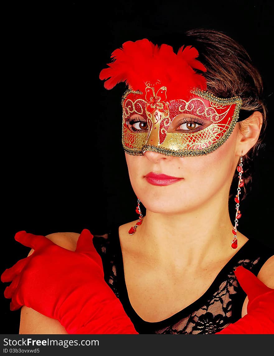 Portrait of beautiful young woman wearing red italian glows and mask. Shooting for black carnival. Portrait of beautiful young woman wearing red italian glows and mask. Shooting for black carnival.