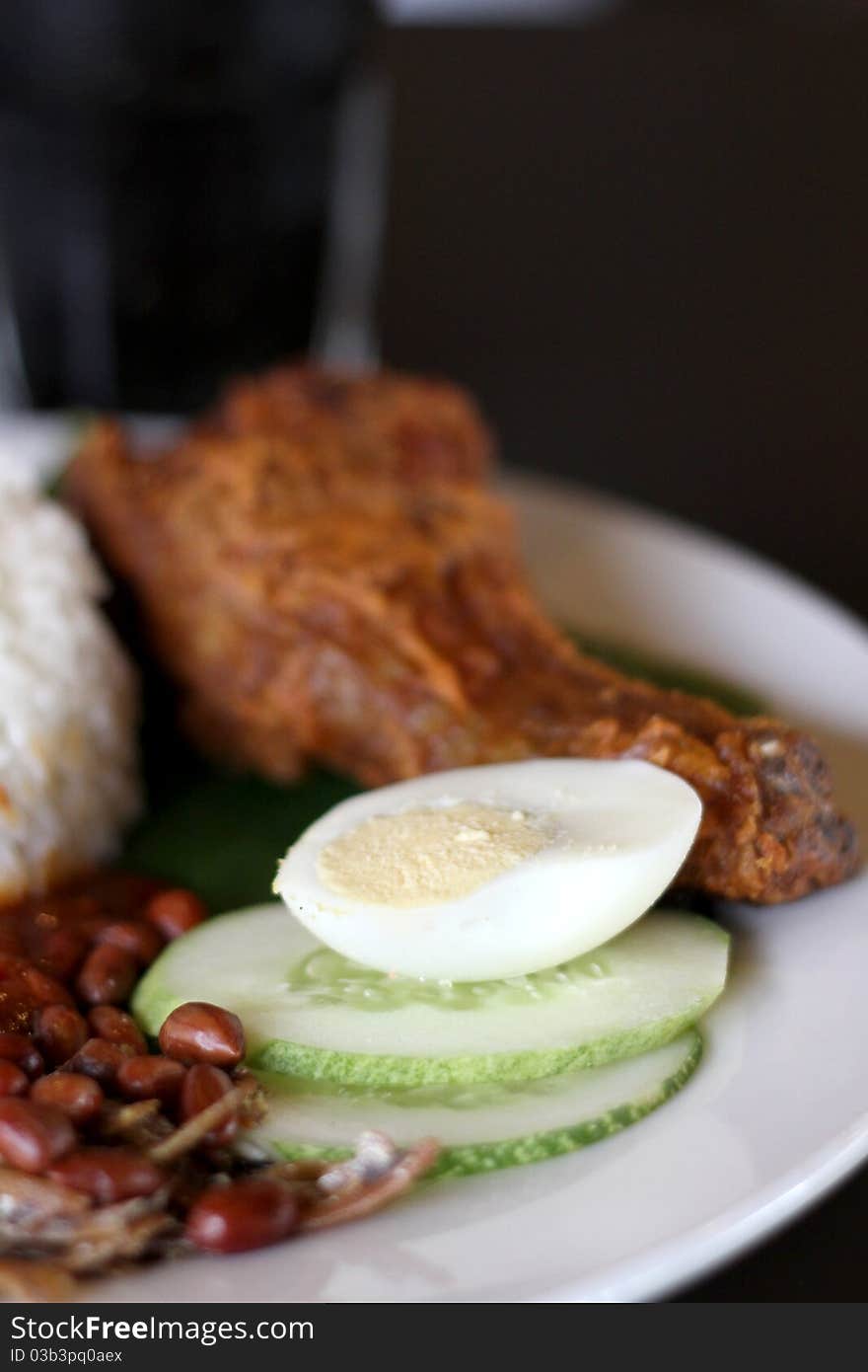 Rice boiled in coconut milk, accompanied by curry and sambal. Rice boiled in coconut milk, accompanied by curry and sambal