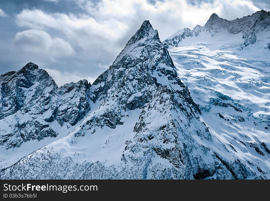 Snow-covered tops of the Caucasian mountains in Russia. Snow-covered tops of the Caucasian mountains in Russia.