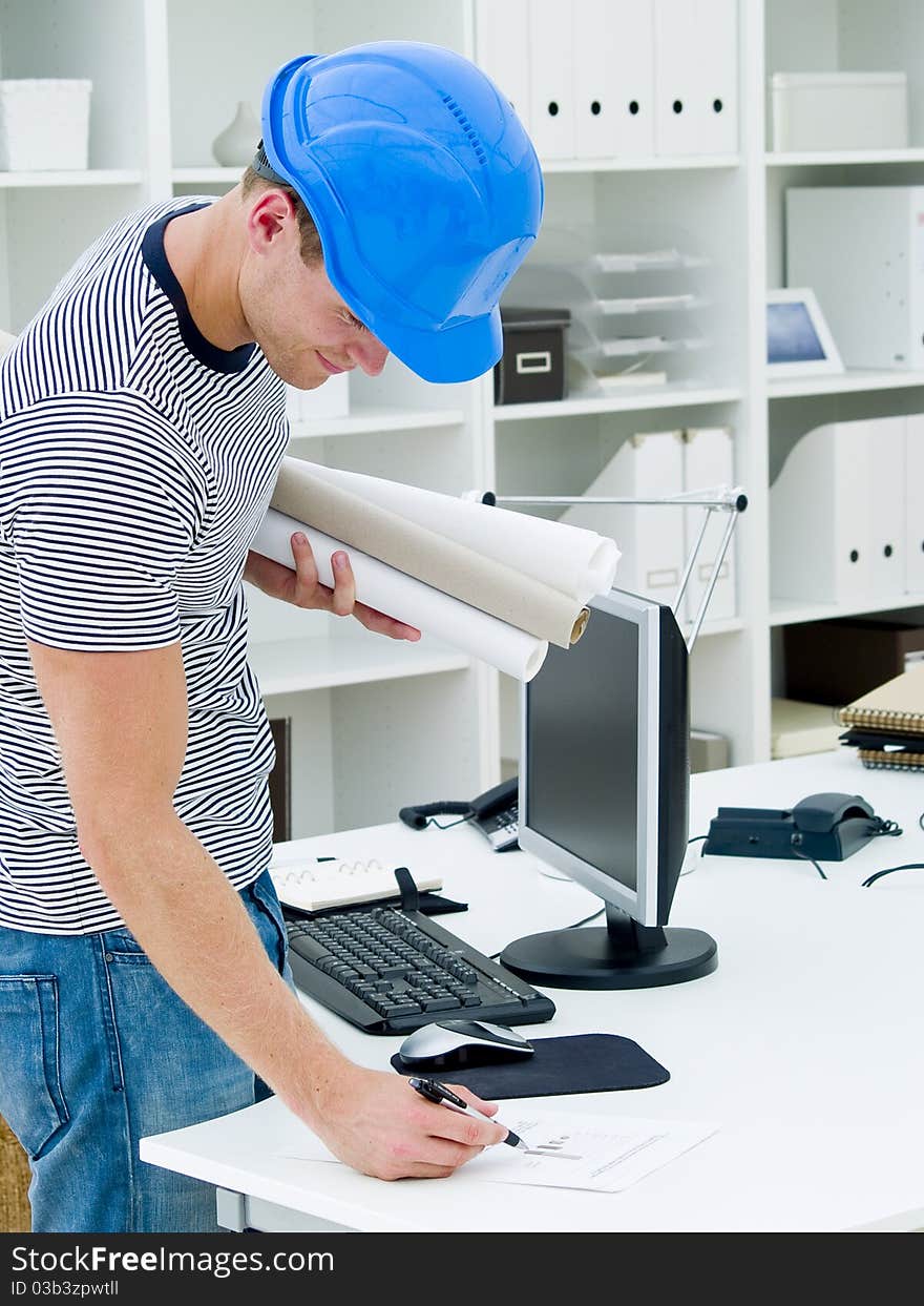 Construction worker looking at the diagrams and blueprints