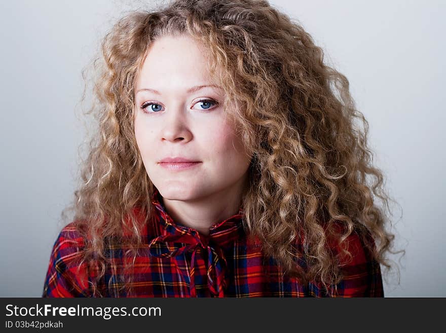 Portrait of beauty woman with blonde curly hairs with blue eyes