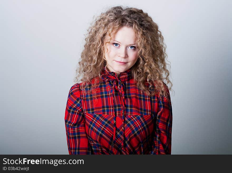 Portrait of beauty woman with blonde curly hairs with blue eyes