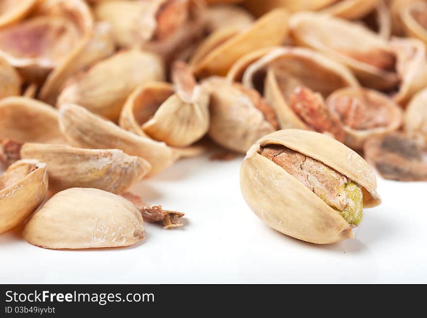 Macro view of last pistachio in the heap of nutshells