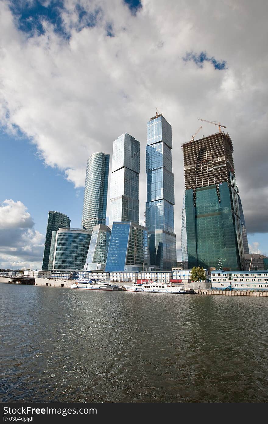 Many scyscrapers of Moscow city under blue sky with clouds