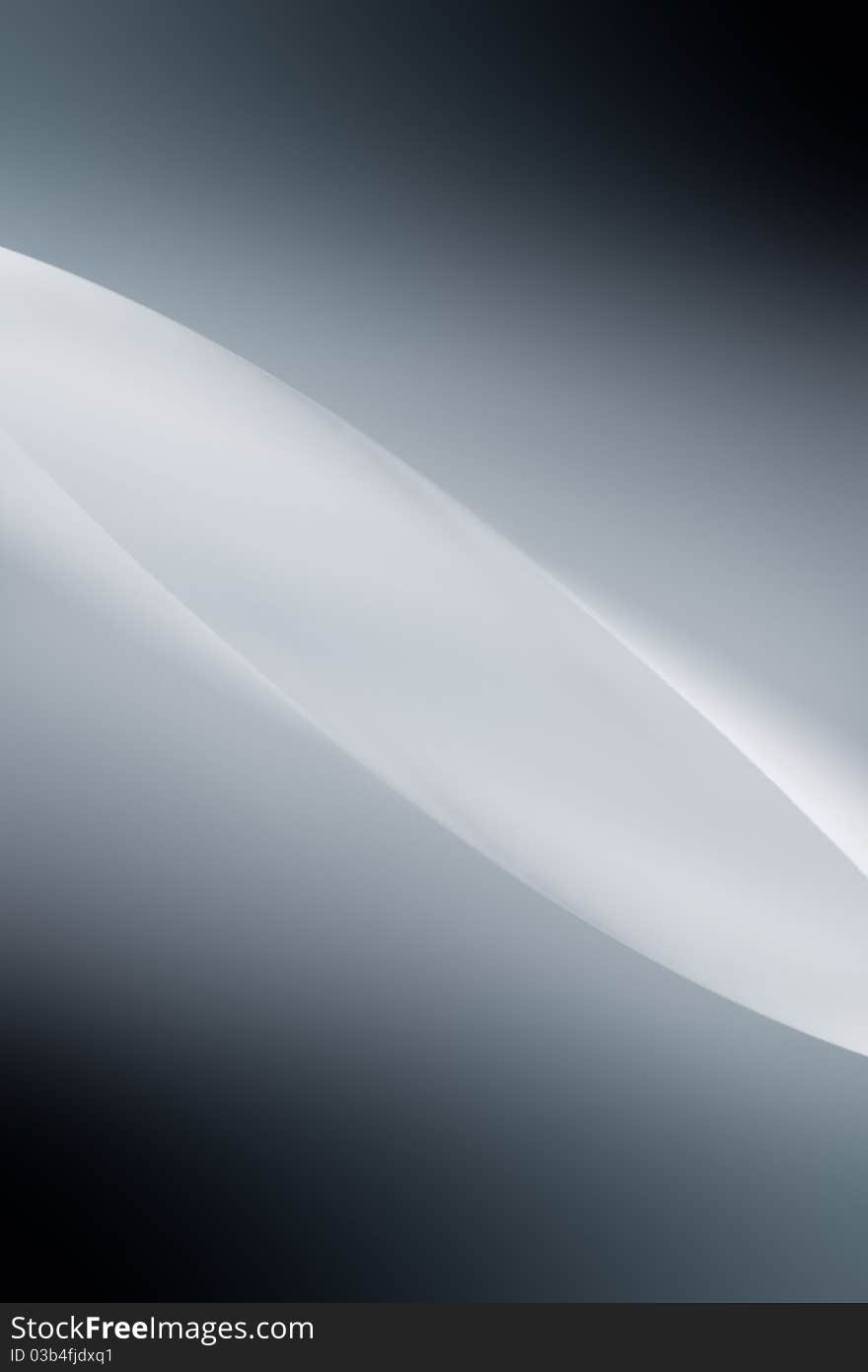 A macro, abstract, background picture of a white sheet of paper, in a lentil, curved shape. A macro, abstract, background picture of a white sheet of paper, in a lentil, curved shape.