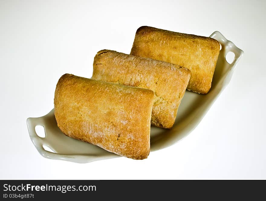 Ciabatta bread rolls on porcelain dish