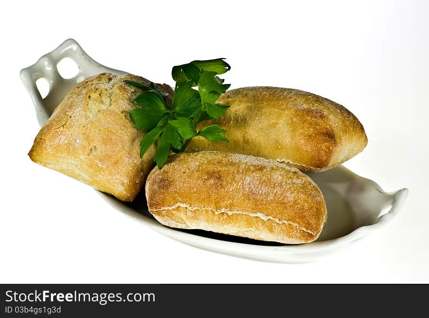 Ciabatta bread rolls on porcelain dish