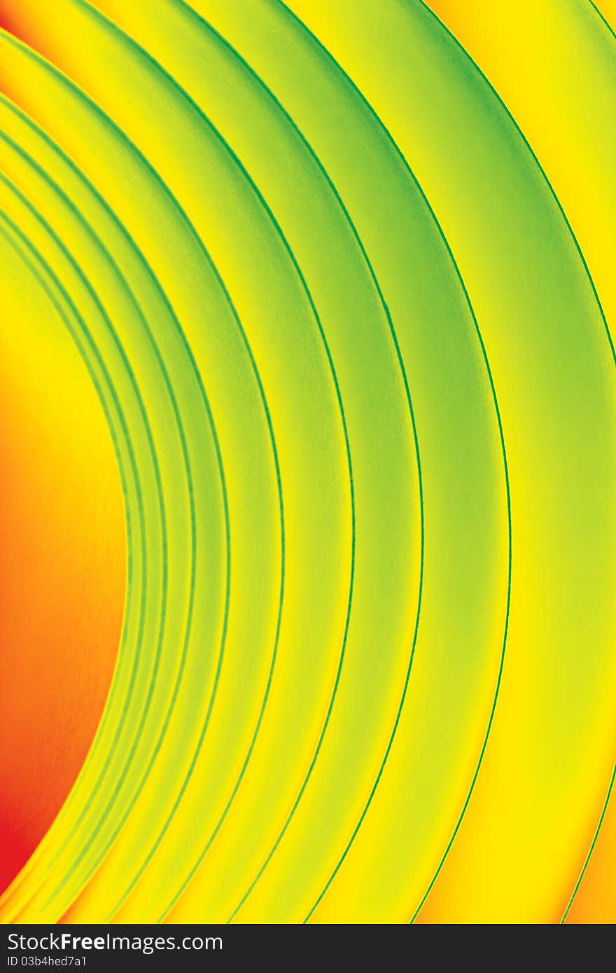 Background macro image of a pattern made of curved sheets of paper in yellow, orange and green colour tones. Background macro image of a pattern made of curved sheets of paper in yellow, orange and green colour tones.