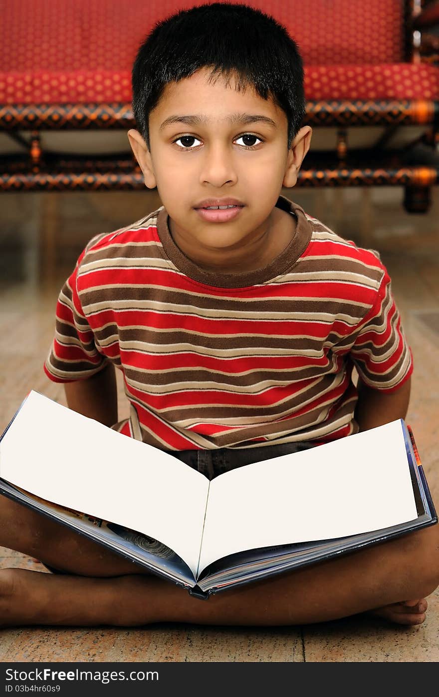 An handsome Indian boy learning music with an electric piano