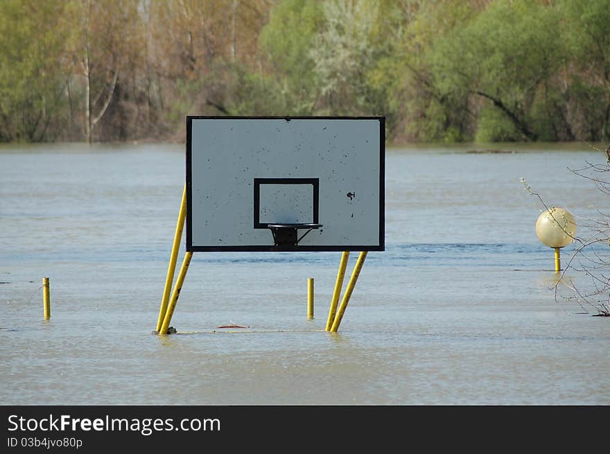 Flooded basketball court. basket under water