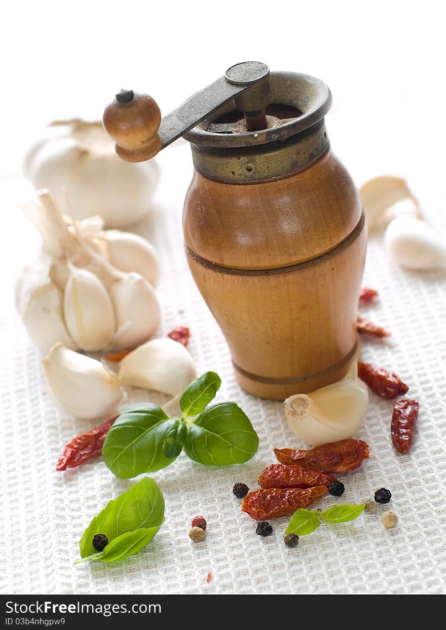 Garlic, dried chili pepper, black pepper and basil on kitchen towel. Garlic, dried chili pepper, black pepper and basil on kitchen towel