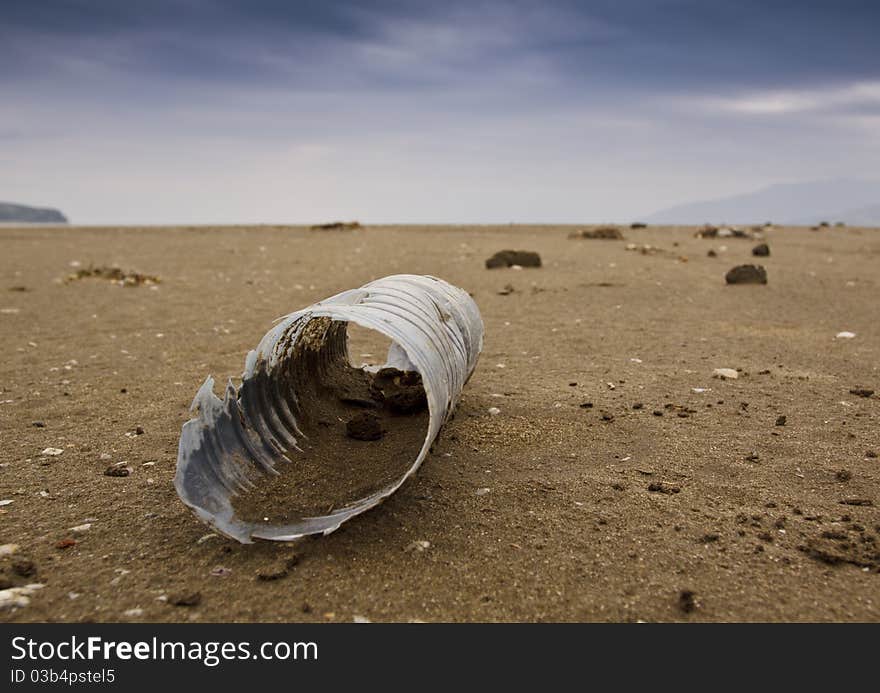 A plastic bottle on a beach. A plastic bottle on a beach