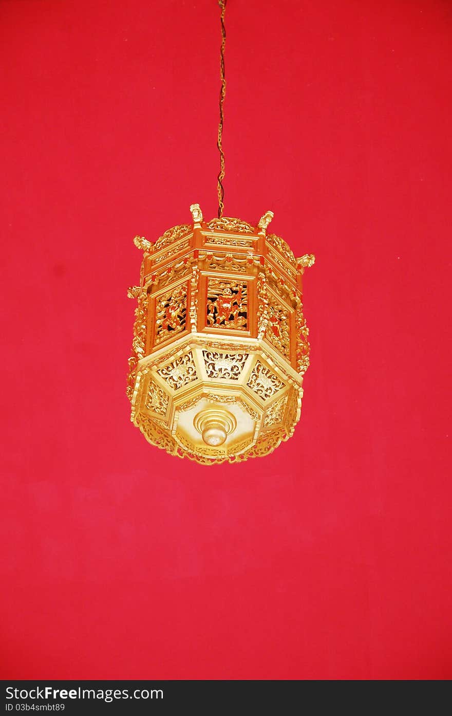 Image of gold lantern with red as background