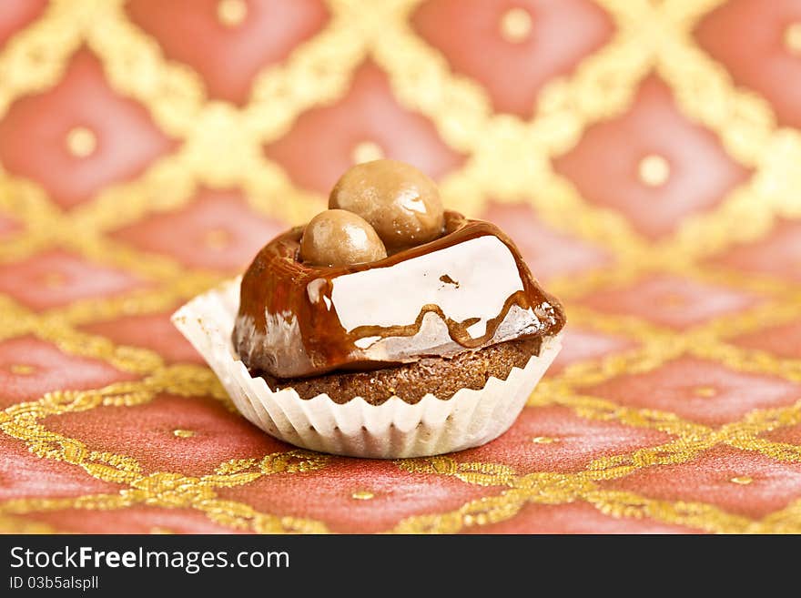 Beautiful little cake on colorful wallpaper background