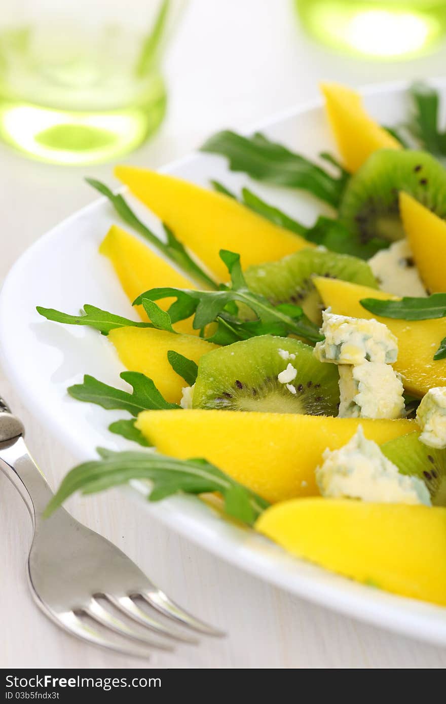 Fresh salad with mango, kiwi and blue cheese