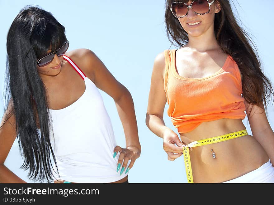 Young woman measuring waist