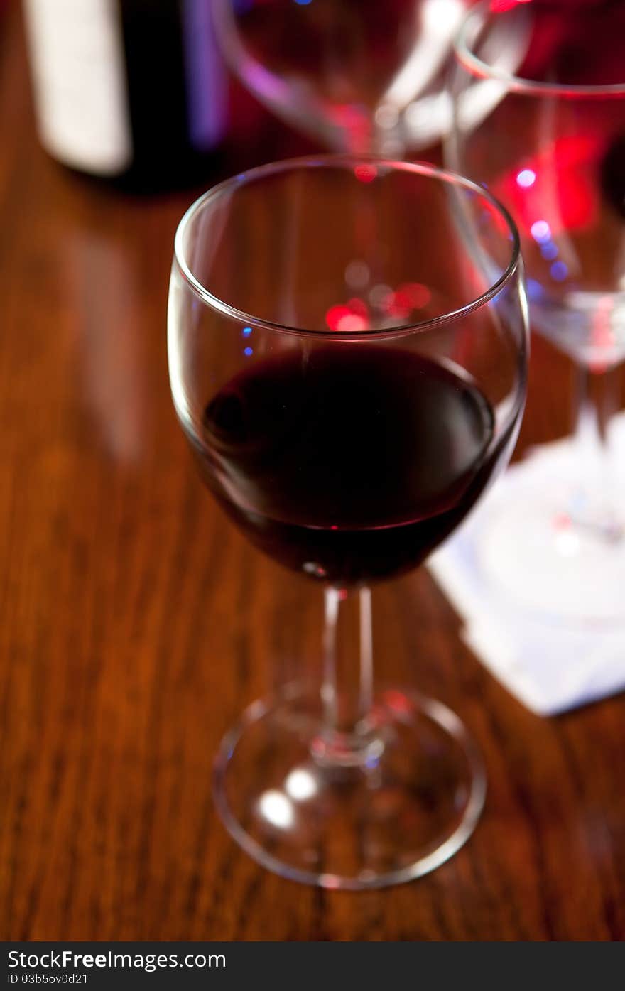 Wine Glasses and bottles on a bar. Wine Glasses and bottles on a bar