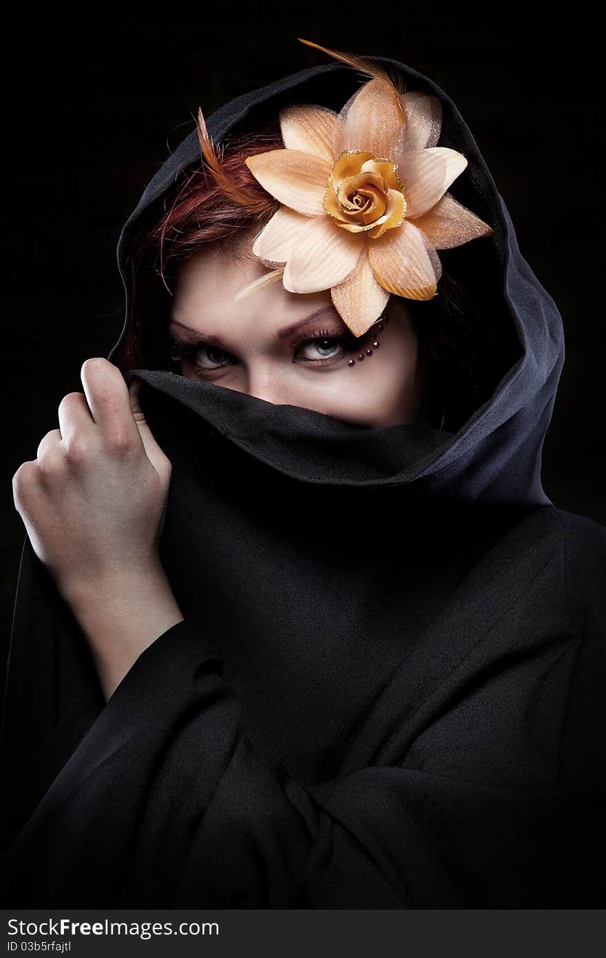 Portrait of woman in black hood with flower. Portrait of woman in black hood with flower